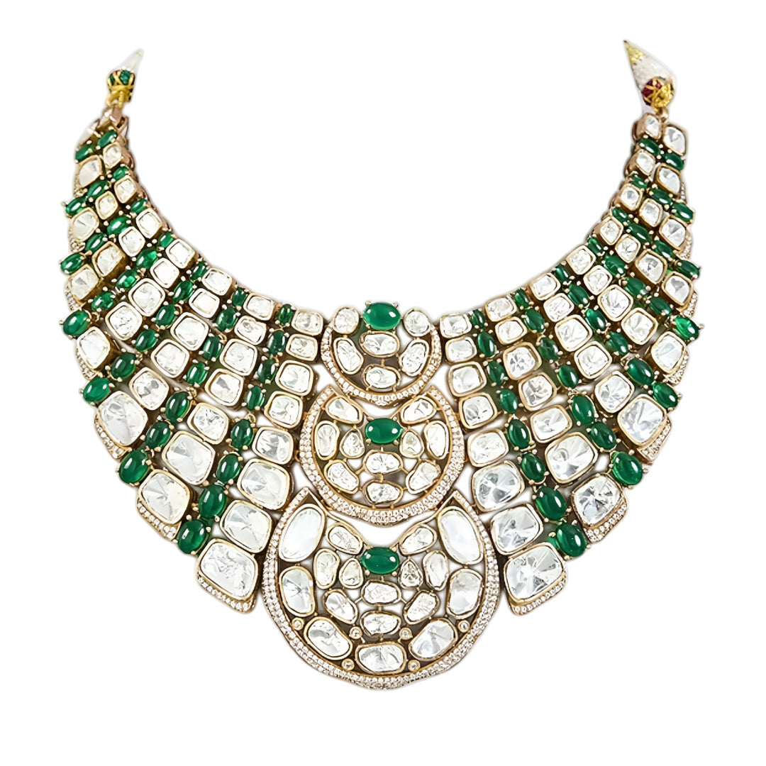 Luxury Kundan Polki necklace set with matching earrings featuring uncut Polki diamonds, green emerald accents, and traditional bridal jewelry craftsmanship in a gold finish.