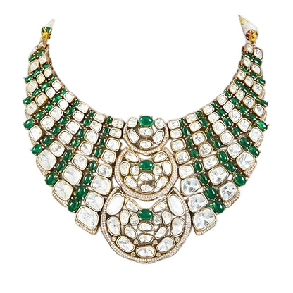 Luxury Kundan Polki necklace set with matching earrings featuring uncut Polki diamonds, green emerald accents, and traditional bridal jewelry craftsmanship in a gold finish.