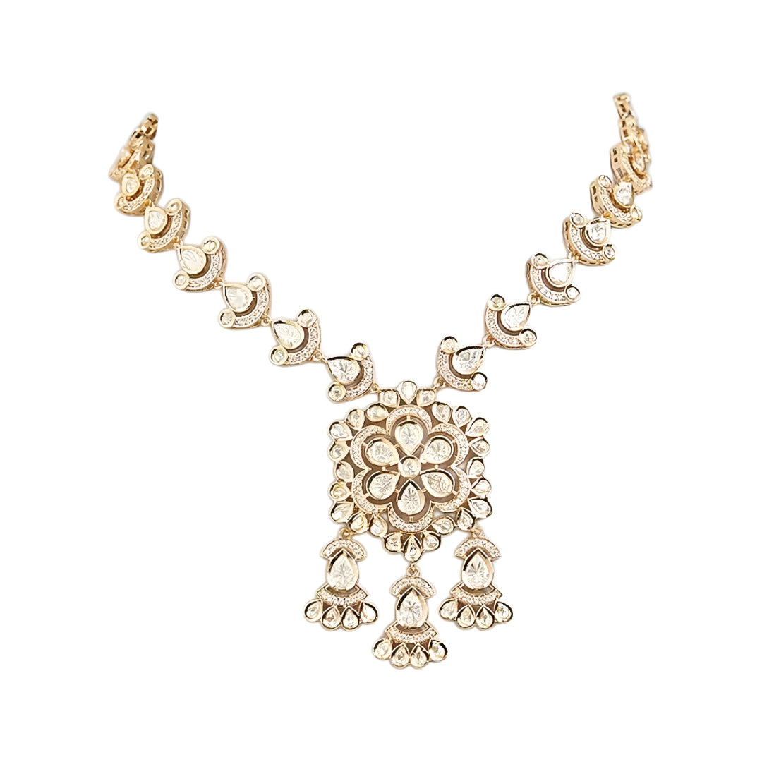 Gold-tone Kundan floral necklace set featuring a statement pendant with dangling accents and matching drop earrings on a white background.