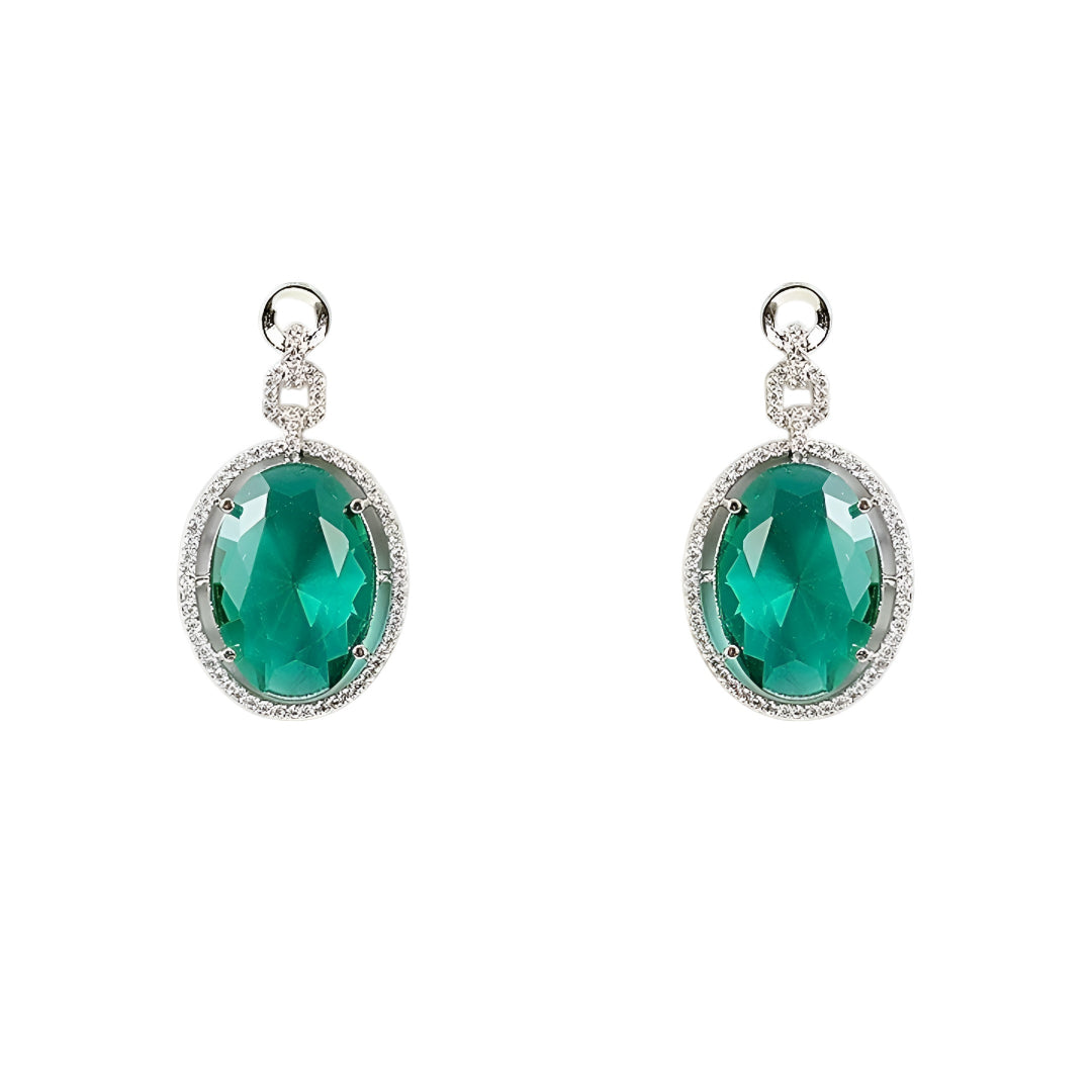 Silver-toned necklace set featuring an emerald green oval crystal pendant with matching drop earrings on a white background.