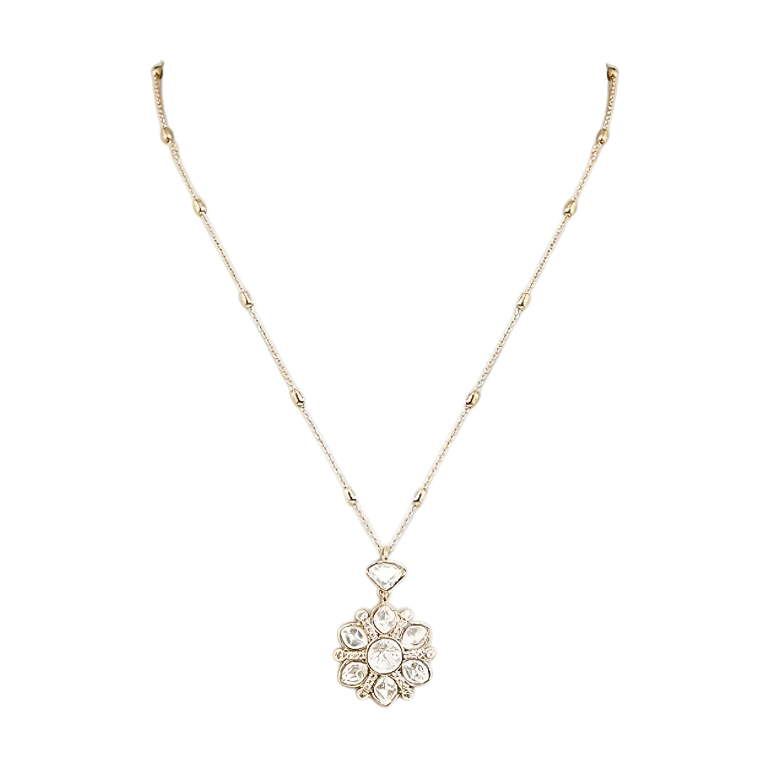 Gold-tone floral crystal pendant necklace with matching crystal earrings jewelry set featuring sparkling clear stones and elegant flower design.