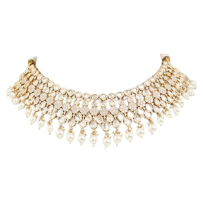 Gold-toned Kundan pearl choker necklace set featuring floral motifs, teardrop stones, pearl danglers, and matching earrings on a white background.