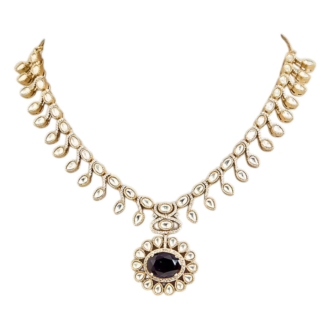 Gold-tone Kundan-inspired necklace and earrings set featuring white stones and deep purple oval gemstone accents in an elegant traditional design.