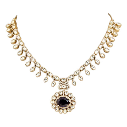 Gold-tone Kundan-inspired necklace and earrings set featuring white stones and deep purple oval gemstone accents in an elegant traditional design.
