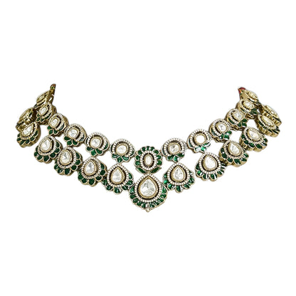 Green Kundan Polki bridal necklace set with matching earrings featuring white stones and emerald green accents in antique gold finish.