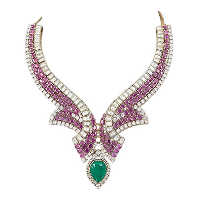 Luxury emerald, ruby and diamond necklace set with matching earrings in white gold featuring pear-shaped emerald gemstones, pink ruby accents and sparkling diamond detailing.