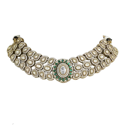 Elegant diamond and emerald choker necklace set with matching stud earrings featuring intricate floral motifs, sparkling white stones, green gemstone accents, and a luxurious gold-tone finish.