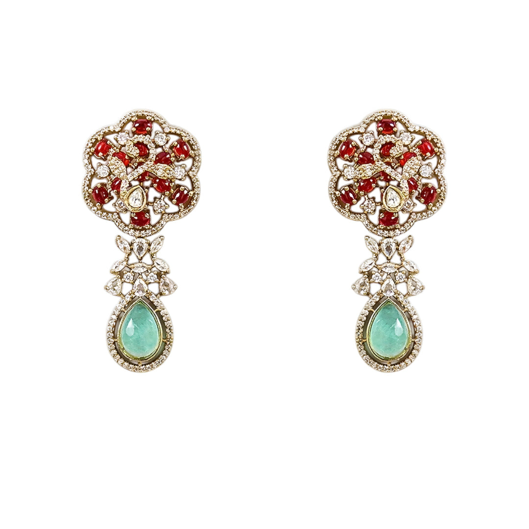 Designer ruby red kundan choker necklace set with sparkling crystal detailing, mint green teardrop gemstone centerpiece, and matching earrings for bridal and festive occasions.