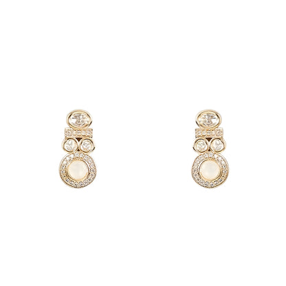 Gold-tone statement necklace set with ivory cabochon stones, crystal embellishments, and matching earrings on white background.