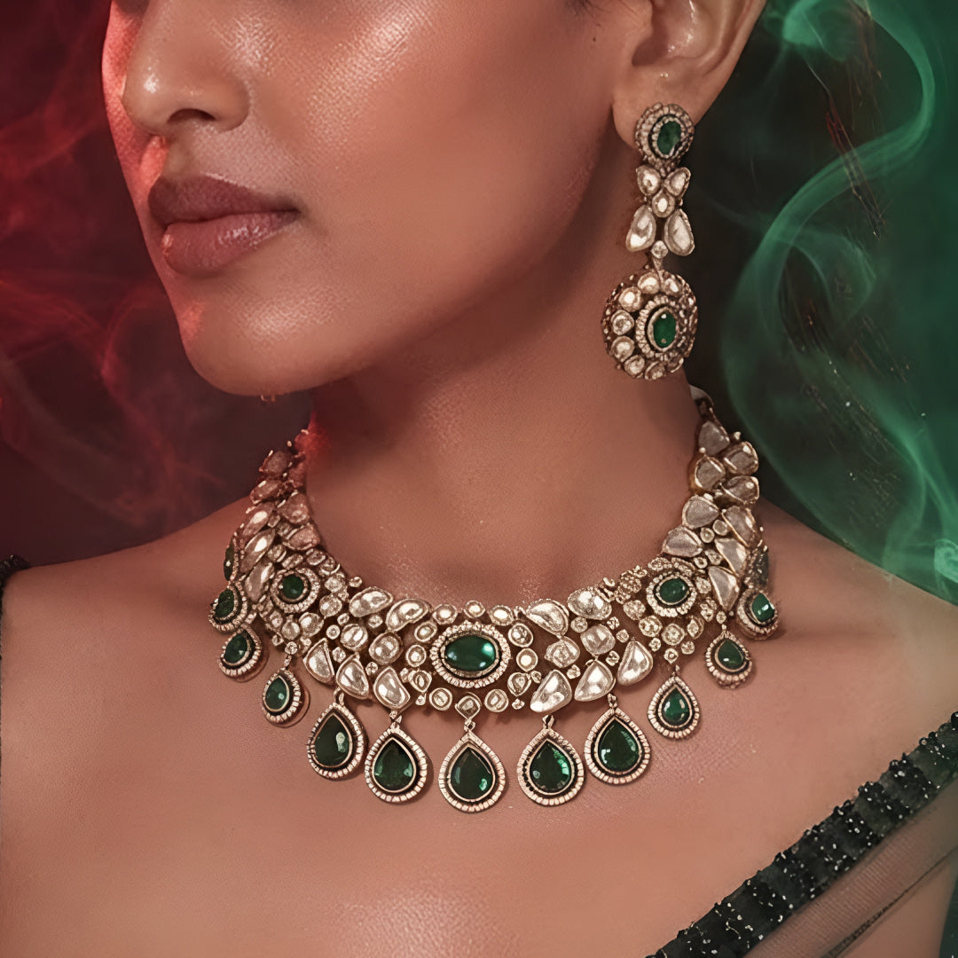 "Gold-tone Kundan choker necklace set with emerald green teardrop drops and matching earrings"