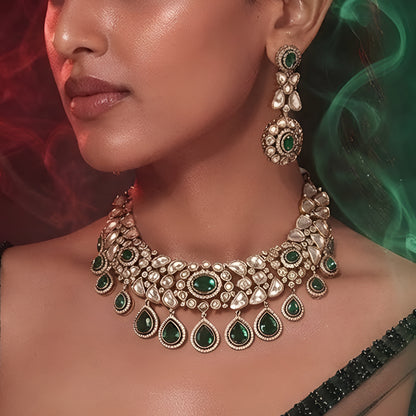 "Gold-tone Kundan choker necklace set with emerald green teardrop drops and matching earrings"