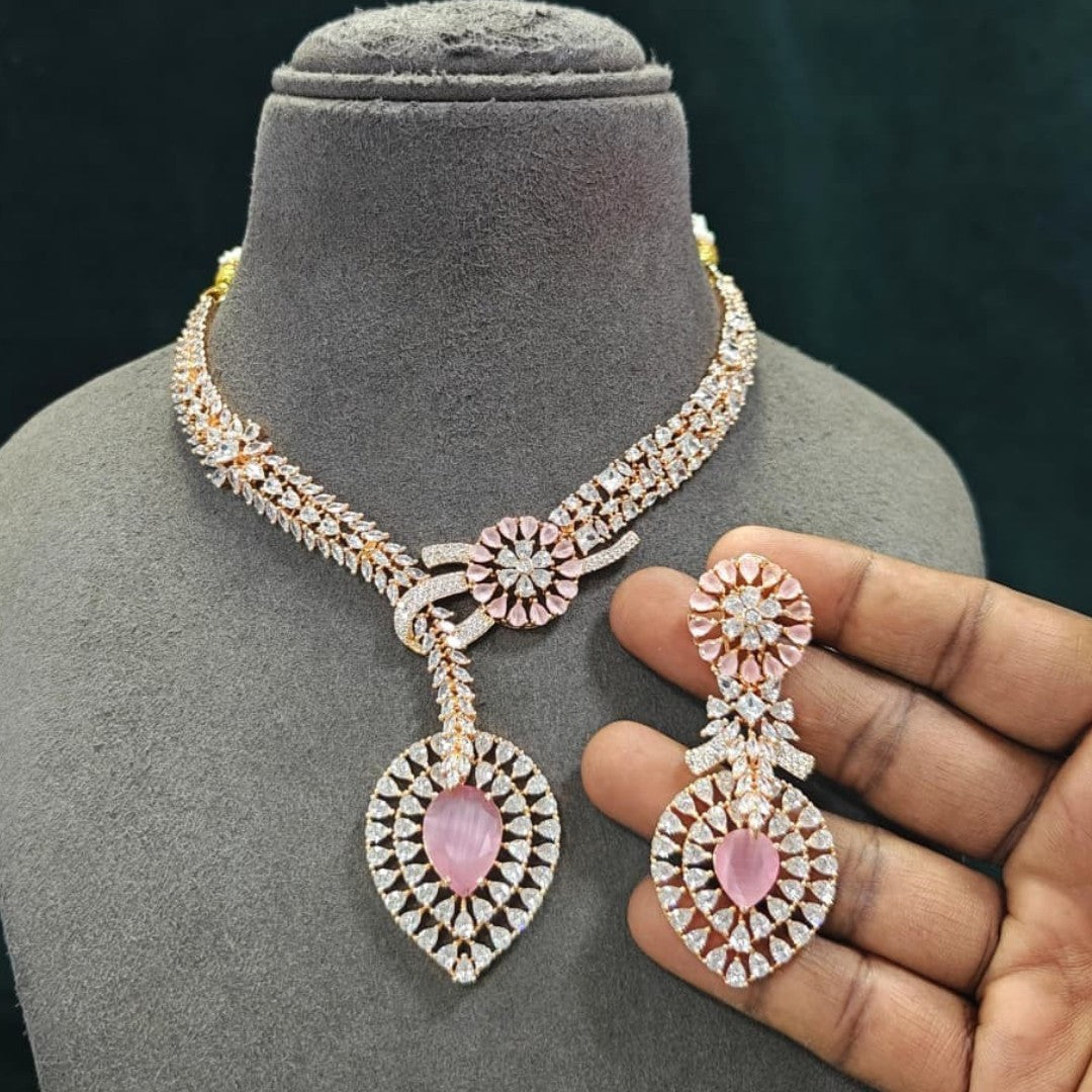 Rose gold plated pink American diamond necklace set with knot design, pink pear drop pendant and matching earrings