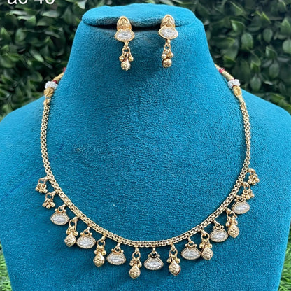 Antique gold finish necklace set with clear marquise polki stone charms and gold bead drops
