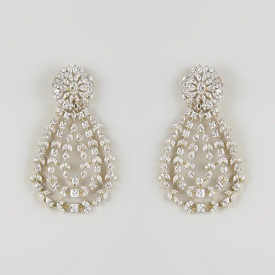 Gold-toned white stone chandelier earrings with floral top and teardrop design"