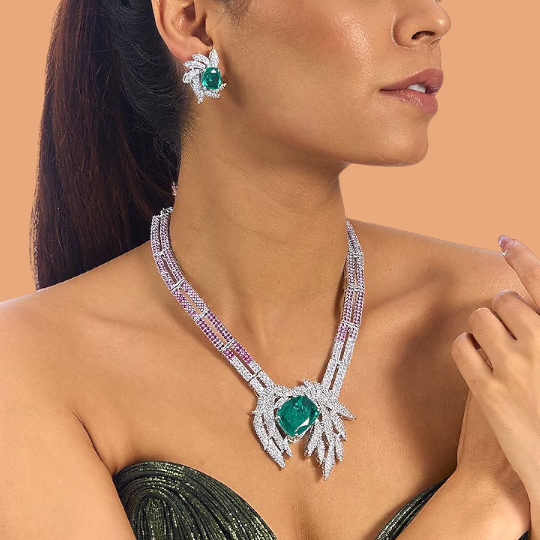 Emerald and diamond leaf design necklace and earrings set with ruby-pink accents on silver base – luxury women’s jewelry set
