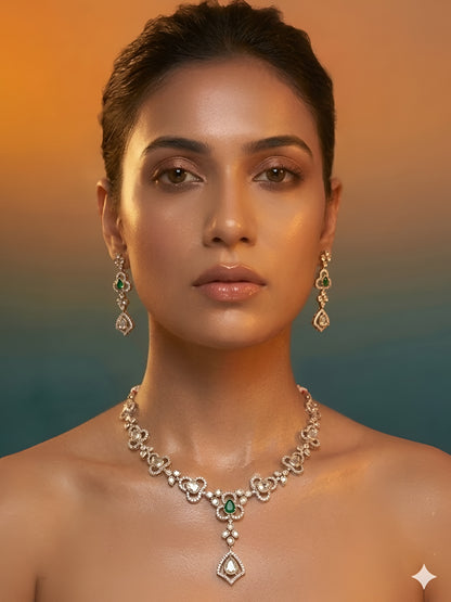 Gold-plated necklace set featuring green stones, American diamonds, floral motifs, and matching drop earrings for women.