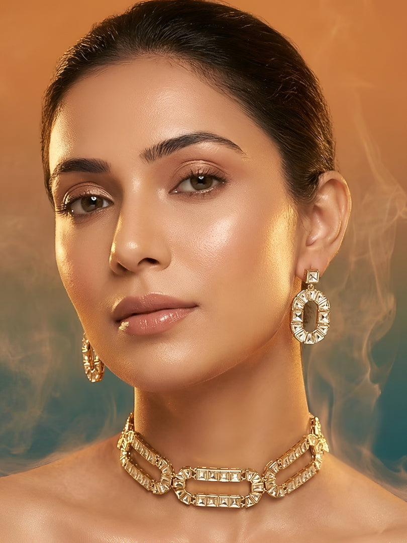 Gold-plated geometric crystal statement necklace set with matching oval drop earrings featuring baguette-cut stones for women.
