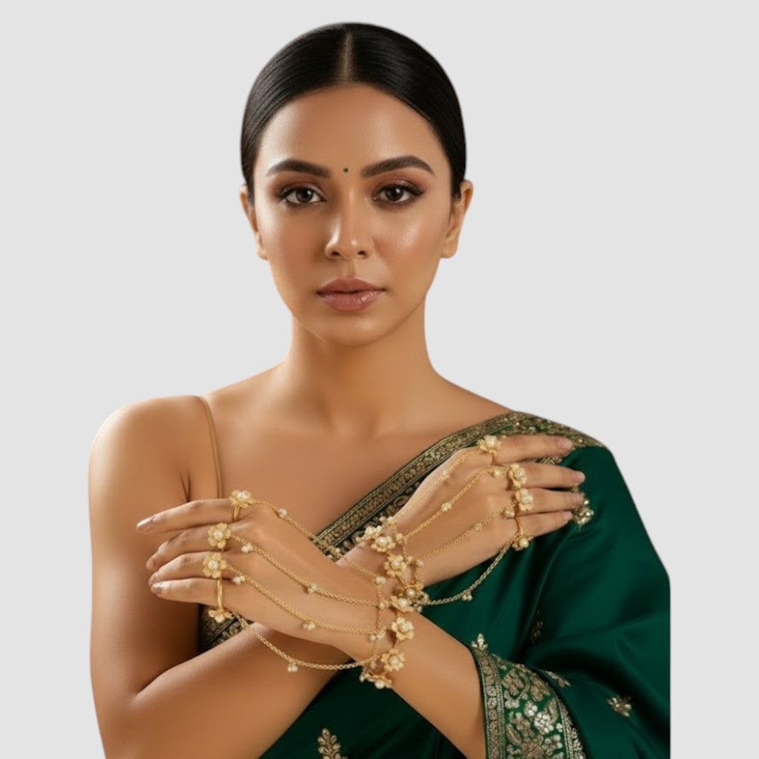 Gold-tone floral pearl hathphool hand harness set with bracelets connected to multiple rings by delicate chains.”