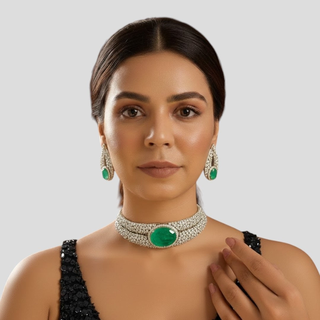 “Silver-plated choker necklace with large emerald green stone and matching earrings”