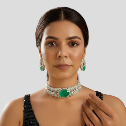 “Silver-plated choker necklace with large emerald green stone and matching earrings”