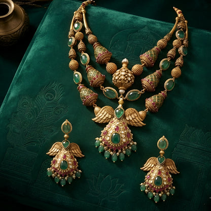"Antique gold plated kundan polki bridal necklace set with emerald and ruby stones, peacock wing pendant design, and matching jhumka earrings"