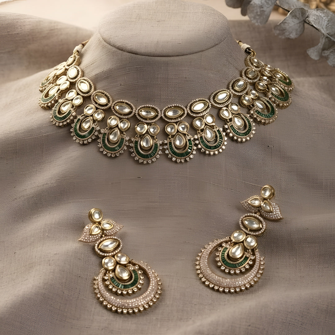 "Antique gold Kundan choker necklace with green baguette crescent accents and matching chandbali drop earrings"