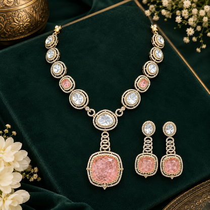 Antique gold Victorian kundan necklace with a large square peach-pink pendant and matching drop earring on a grey display bust