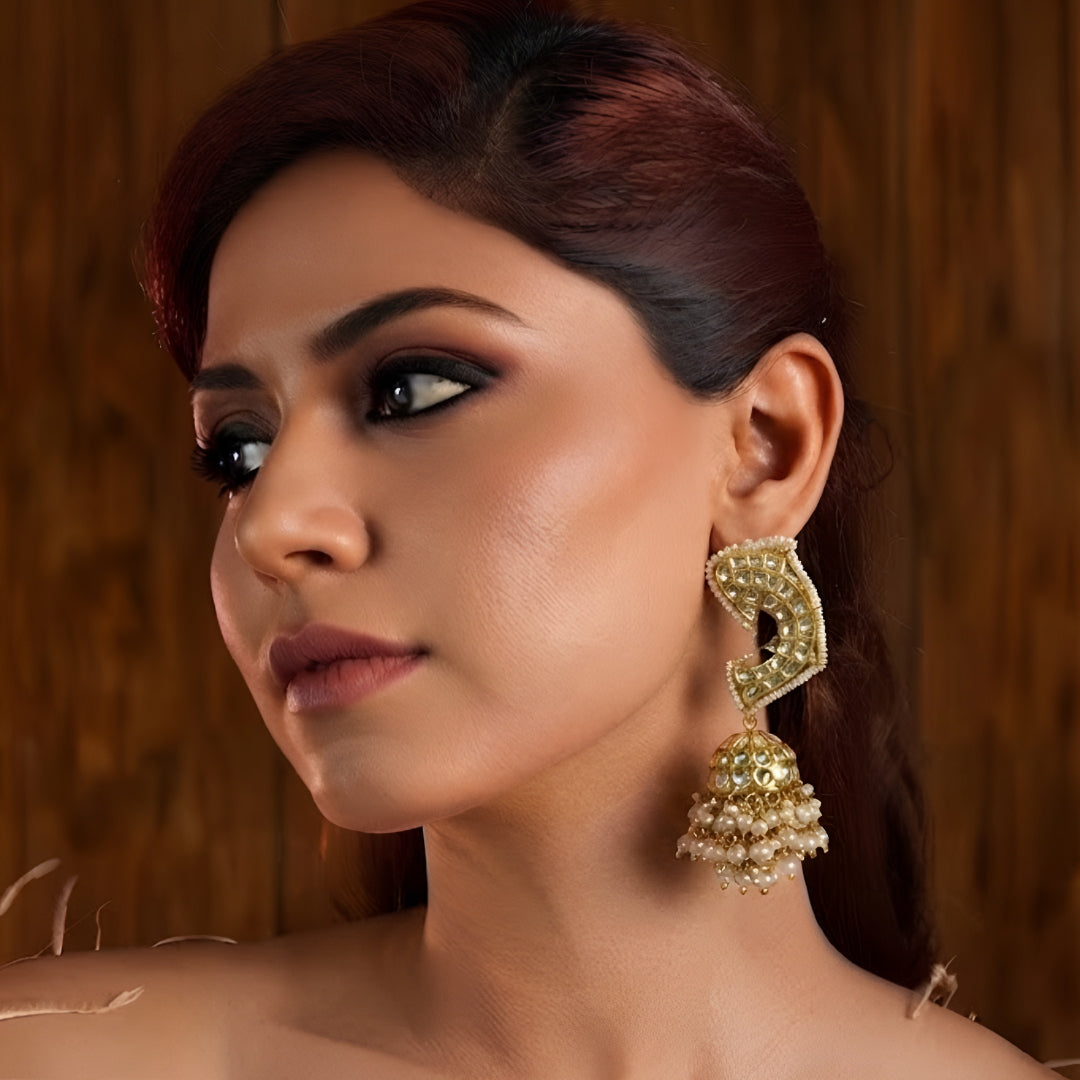 Gold-plated Kundan Jhumka earrings with pearl drops for women, traditional ethnic wedding and festive jewellery.