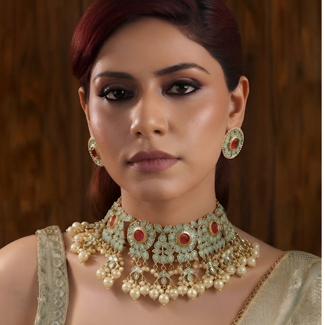 Traditional gold-plated Kundan pearl choker necklace set with ruby-red stones and matching stud earrings for women.