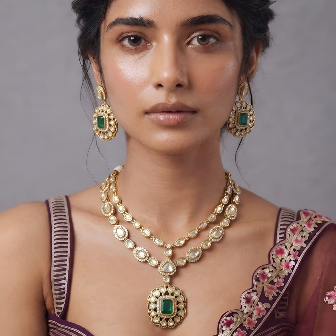 Double layer kundan necklace set with emerald-green pendant and matching kundan drop earrings