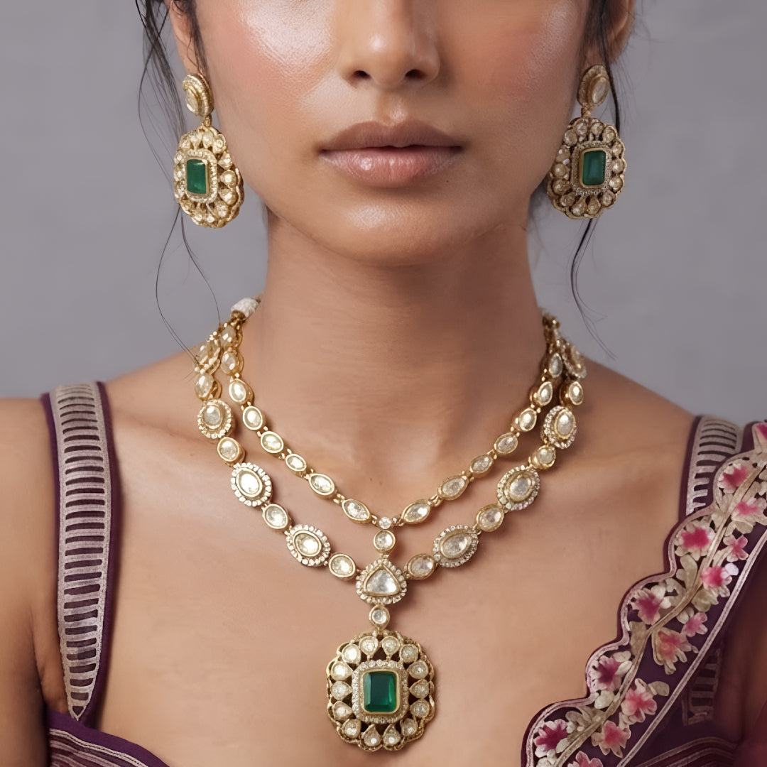 Double layer kundan necklace set with emerald-green pendant and matching kundan drop earrings