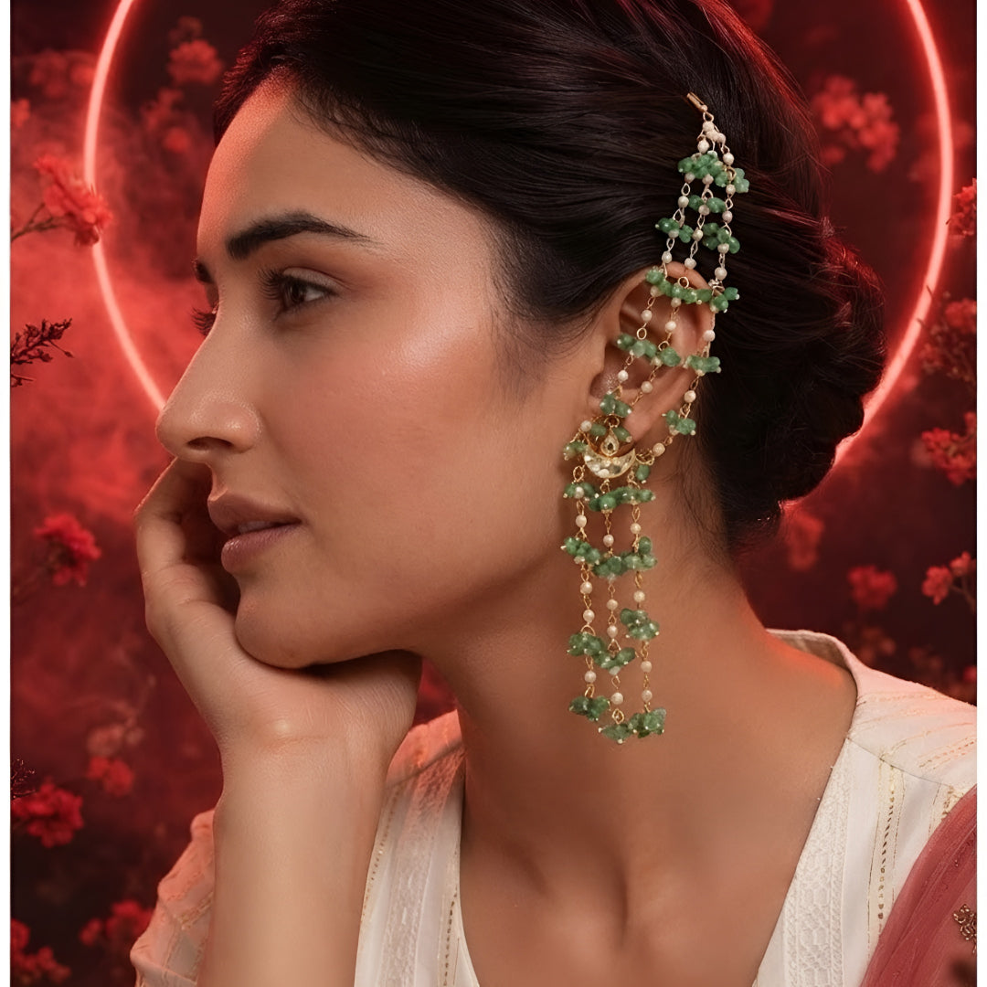 "Gold ear cuff earring with cascading green onyx beads and pearls, worn by model with dark hair in updo"