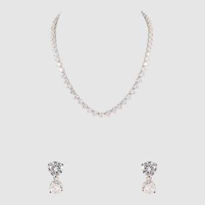 Silver-toned diamond-cut necklace with matching double-stone drop earrings on a light background