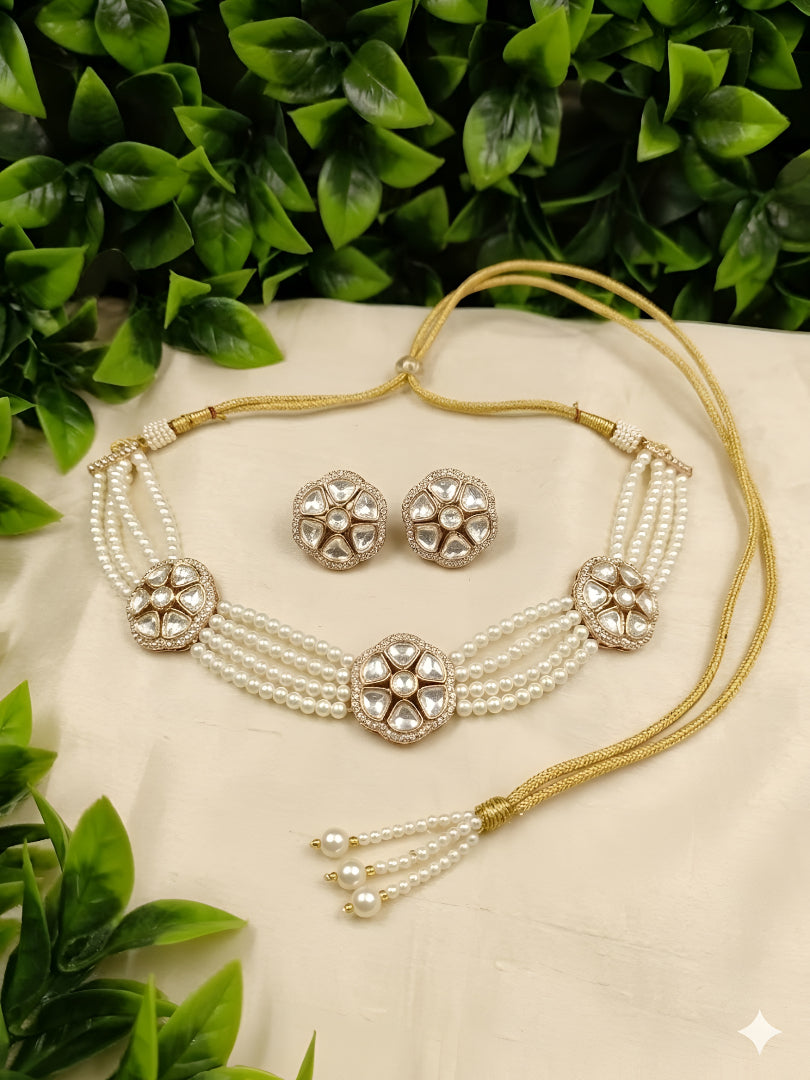 Kundan pearl choker necklace set with matching earrings on white background