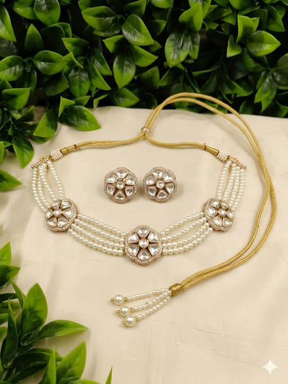 Kundan pearl choker necklace set with matching earrings on white background