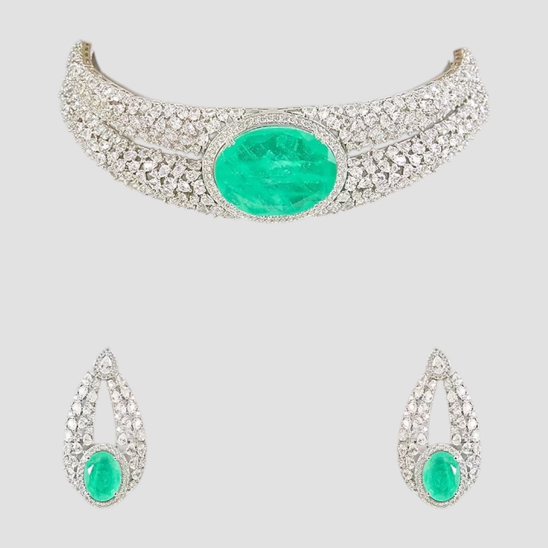 “Silver-plated choker necklace with large emerald green stone and matching earrings”