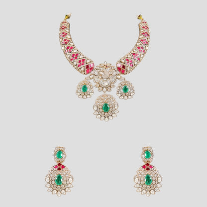 "Traditional Kundan bridal jewelry set with a gold-toned necklace featuring ruby and emerald stones, paired with matching earrings."