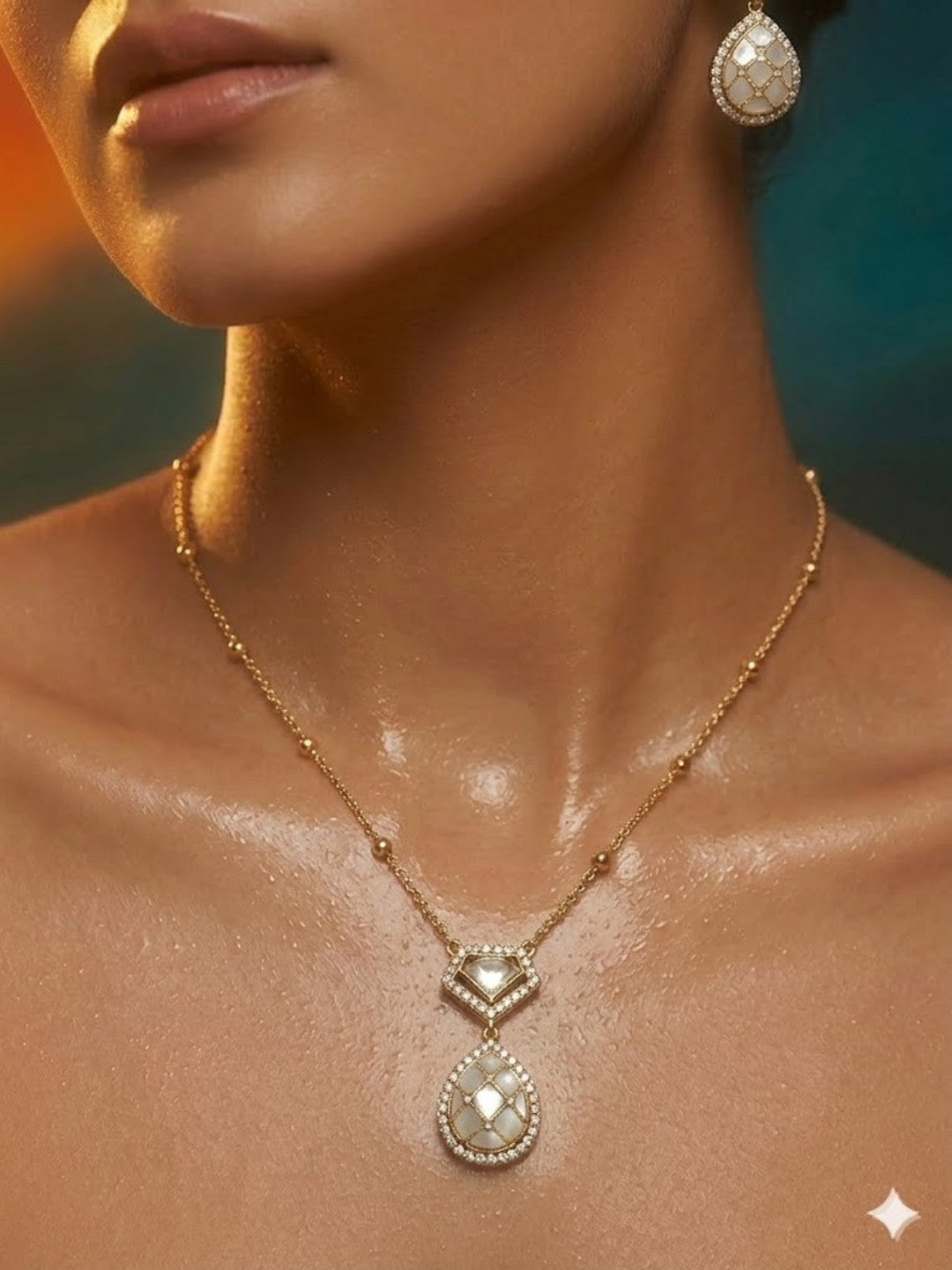 Gold-plated pearl teardrop pendant necklace set with matching stud earrings embellished with American diamonds for women.