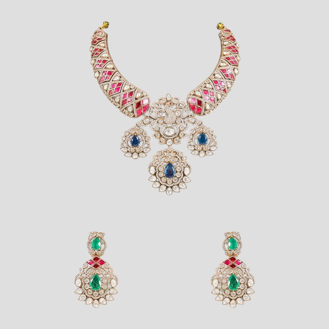"Gold-plated kundan necklace set with pink inlay, blue teardrop stones, green emerald drops, and matching earrings"
