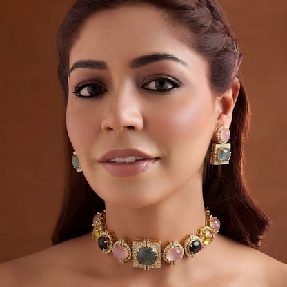 Gold-plated multicolour cabochon choker necklace set with square zircon pavé centre, pink grey and yellow stones and matching two-tier earrings on a display bust