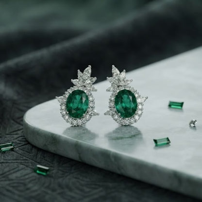 Rhodium plated emerald green oval stud earrings with marquise CZ floral crown halo design