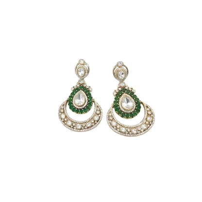 Gold Victorian kundan bridal choker with emerald-green ringed pear drops and matching crescent chandelier earrings on dark green velvet