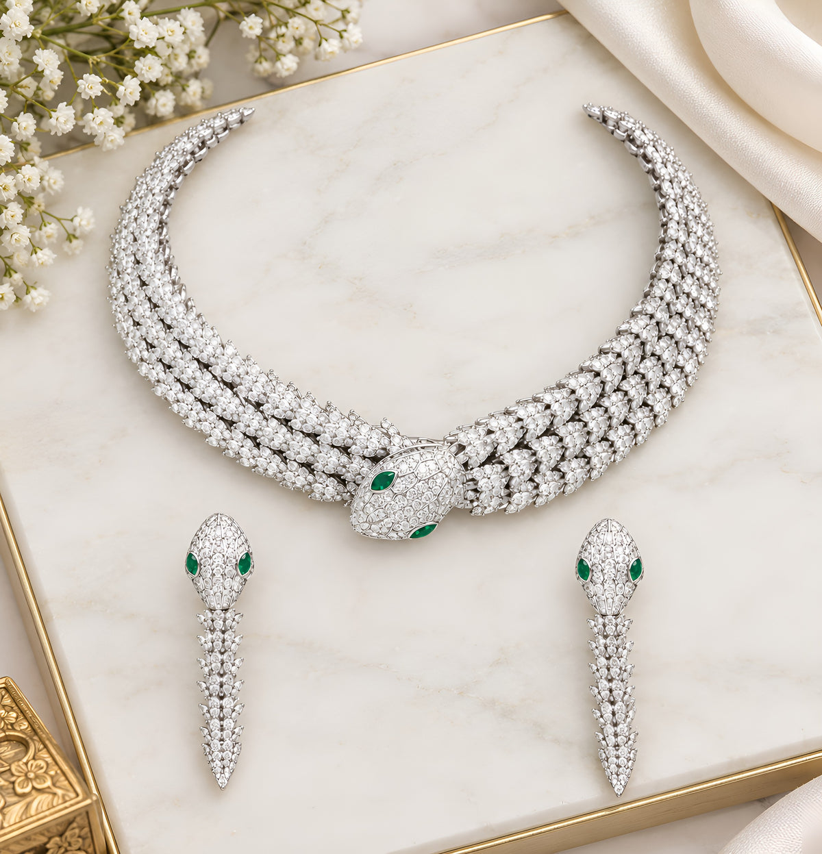 Rhodium-plated snake-inspired necklace set with green and white stones and matching earrings
