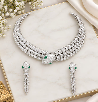 Rhodium-plated snake-inspired necklace set with green and white stones and matching earrings