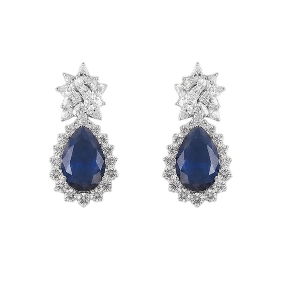 "Silver rhodium-plated V-shaped necklace set with white American diamonds and blue sapphire pear-drop stones, paired with matching teardrop earrings"
