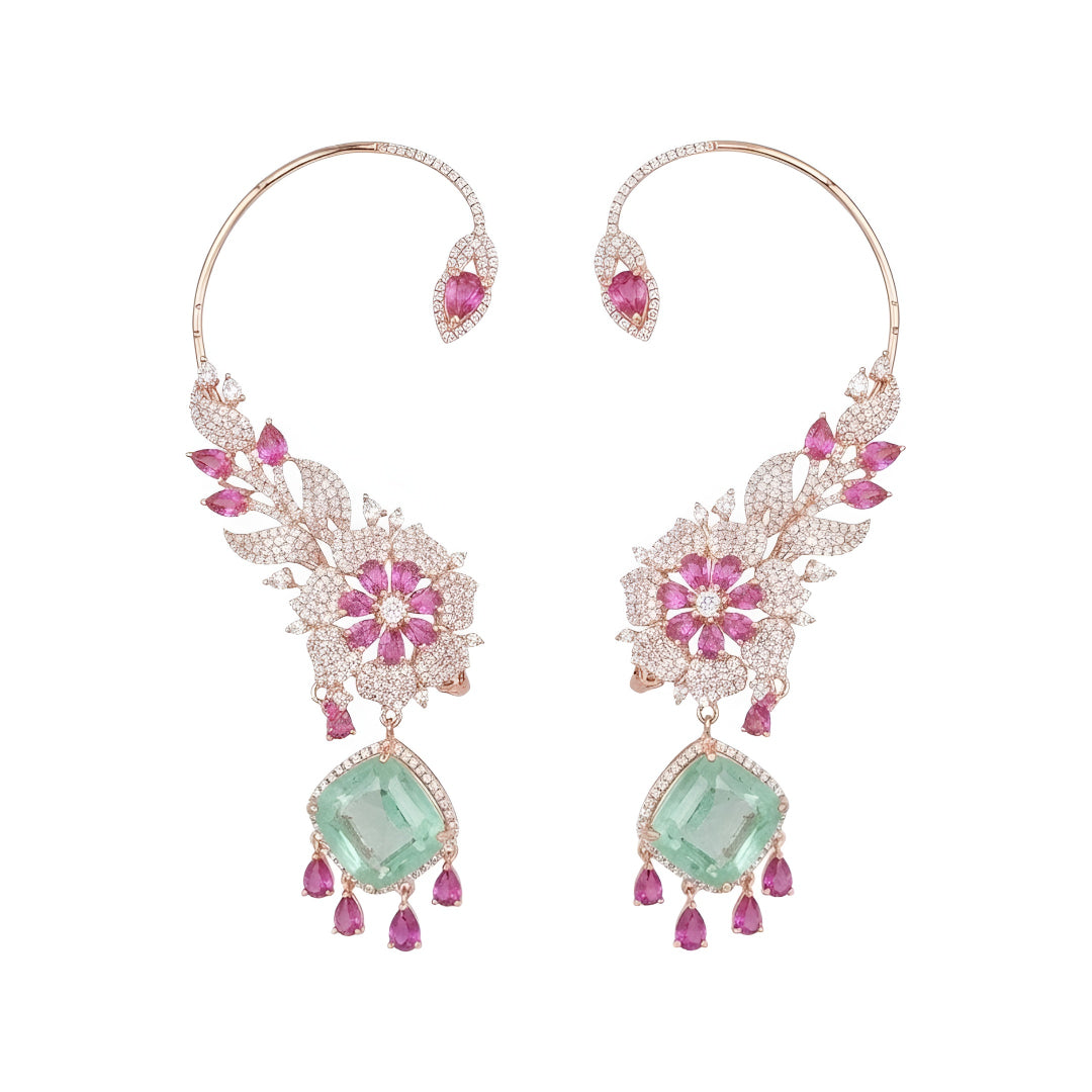 Rose gold American diamond ear cuff earrings with ruby pink pear stones and mint green cushion-cut drops, held in hand