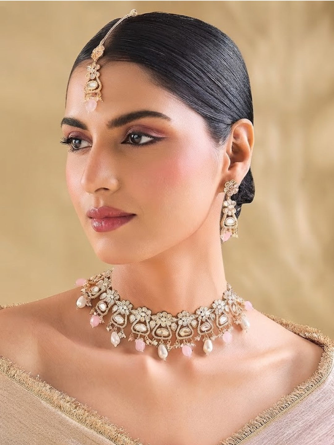 Gold-plated floral Kundan choker necklace set with pink beads, pearl drops, and matching earrings for bridal, wedding, and festive wear.