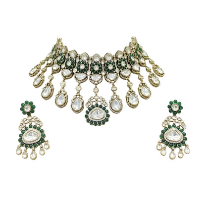 Antique gold Victorian kundan bridal choker with emerald-green flower medallions, pear-stone drops and a matching drop earring on a grey display bust