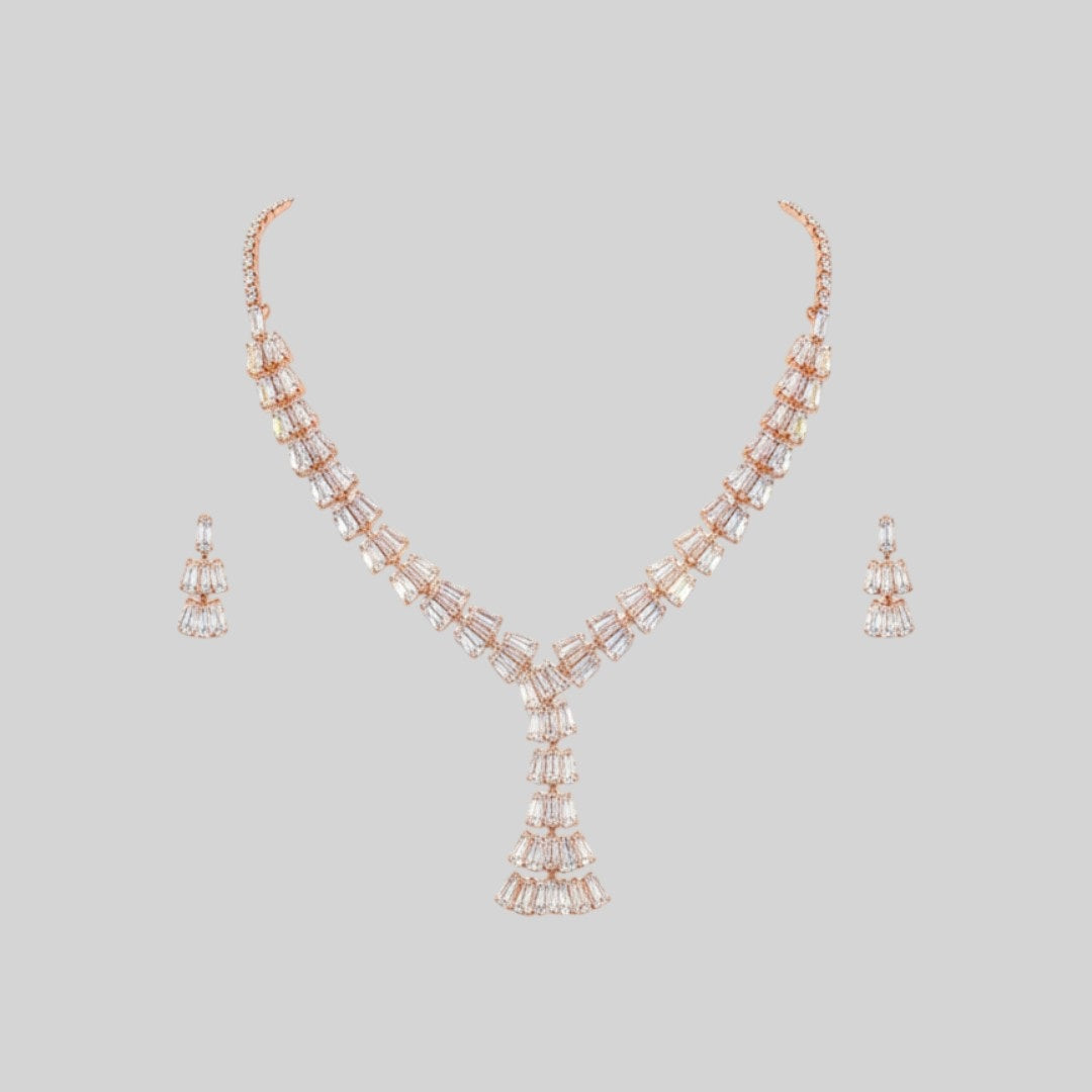 Elegant leaf design American diamond necklace with green stone detailing and matching earrings on red velvet display stand