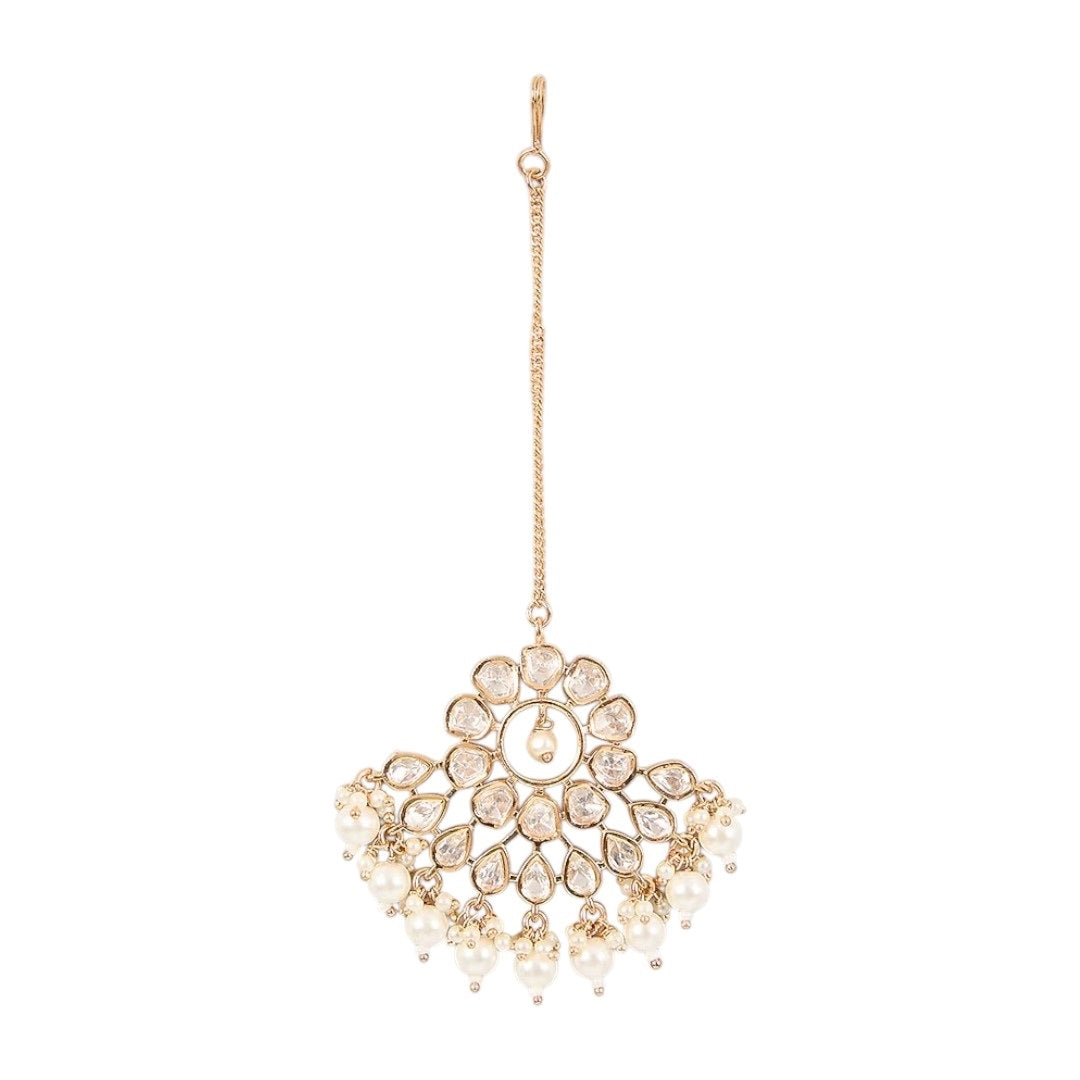 Gold-plated floral kundan maang tikka with pearl drops on a light background